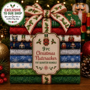 May include: A 9-piece Christmas Nutcracker fat quarter fabric bundle stacked and tied with a holly-patterned ribbon. The fabric features various holiday prints including nutcrackers, snowflakes, and stars in red, green, blue, and cream colors.