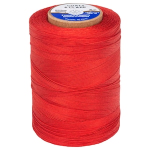 May include: A spool of red Coats & Clark machine quilting thread. The spool is labeled with 1200 yards/ 1097 meters.