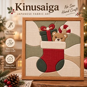 May include: A square Kinusaiga Japanese fabric art piece in a wooden frame featuring a red Christmas stocking with a teddy bear, a green gift box, and a candy cane. The text reads Kinusaiga Japanese Fabric Art, No Sew Hand Craft, No Sew Technique, Relaxing Hand Craft, and Beautiful Home Decor.