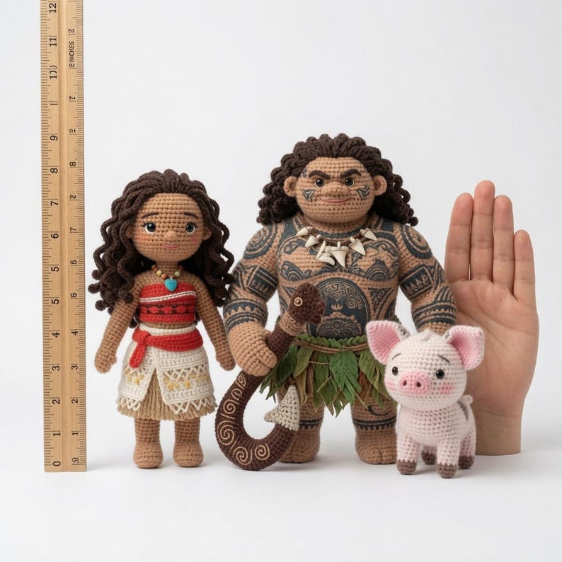 May include: Three crocheted dolls featuring a female figure with dark curly hair, a male figure with extensive dark tattoos and a hook, and a small pink pig. A wooden ruler shows the female doll is approximately 6 inches tall.