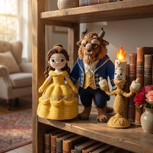 May include: Three crocheted dolls representing a female figure in a yellow gown, a brown furry creature in a blue coat, and a golden candelabra with a flame. The figures are arranged on a wooden shelf alongside several vintage hardcover books.