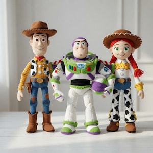 May include: Three crocheted dolls representing characters from Toy Story. On the left, a cowboy doll with a brown hat, yellow shirt, and blue pants. In the center, a space ranger doll in white, green, and purple. On the right, a cowgirl doll with red braids, a brown hat, and white pants with black spots.