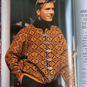 May include: A mustard yellow and brown patterned cardigan with silver clasps. The cardigan has a geometric design and is worn over a black turtleneck. The image is from a magazine.