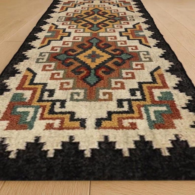 May include: A rectangular runner rug featuring a geometric pattern with repeating diamond shapes. The design incorporates a color palette of cream, black, mustard yellow, terracotta orange, and teal blue, arranged in symmetrical, stepped, and zigzag lines.