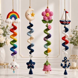 May include: Four hanging crochet ornaments featuring a rainbow with a cloud, a crescent moon with a star, a pink flower, and a sailboat with an anchor. Each piece includes a colorful spiral crochet element, gold chains, and small beads.