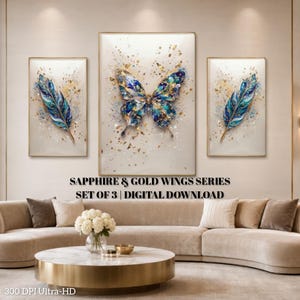 May include: A set of three wall art prints titled SAPPHIRE & GOLD WINGS SERIES SET OF 3 | DIGITAL DOWNLOAD. The central print features a large butterfly, while the two side prints display single feathers, all in shades of blue and gold.