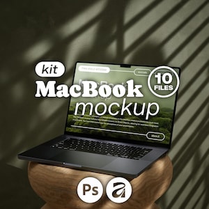 May include: A dark gray laptop displaying a digital interface with the text MacBook mockup, kit, and 10 FILES. The screen shows a website layout with buttons labeled socials and about. Below the laptop are icons for Photoshop and Adobe.
