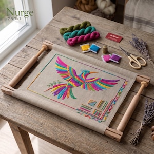 May include: A Nurge 250-1 wooden embroidery frame holding a beige fabric panel with a colourful embroidered bird, small geometric stitch samples, three yarn skeins in green and pink, embroidery floss, a metal thimble, and scissors.