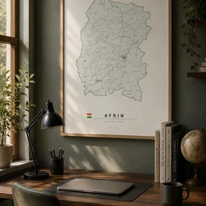 May include: A framed wall art print featuring a detailed black and white map of the Afrin region. The print includes a small flag icon, the text AFRIN, and additional geographic labels in a clean, minimalist layout on a light background.