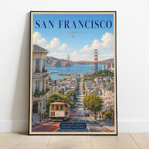 May include: A vertical travel poster featuring a San Francisco cityscape with the Golden Gate Bridge in the distance, a cable car on a steep street, and Victorian architecture. The text reads SAN FRANCISCO USA and BAYLIGHT BEAUTY GOLDEN HORIZONS.