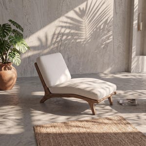 May include: A low-profile lounge chair featuring a curved wooden frame with a natural finish and a thick, off-white upholstered seat cushion. The chair has a reclined backrest and four short, tapered wooden legs, providing a sleek seating option.