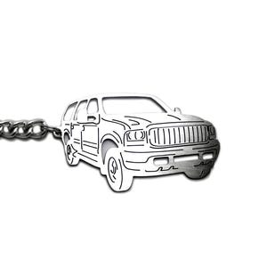 May include: A silver-toned metal keyring featuring a cutout silhouette of a large SUV. The design includes a circular split ring attached to a short chain, which connects to the vehicle shape. The SUV outline shows a front grille, headlights, and wheels.
