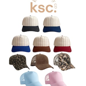 May include: A collection of ten baseball caps featuring the kenz supply co. ksc logo at the top. The assortment includes pinstriped crowns with solid brims in black, navy, blue, brown, and maroon, plus leopard print, brown corduroy, camo, light blue, and pink.