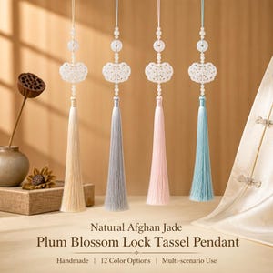 May include: Four hanging ornaments featuring white carved jade lock pendants, small white beads, and long silk tassels in beige, grey, light pink, and light blue. The text reads: Natural Afghan Jade Plum Blossom Lock Tassel Pendant.