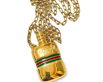 Vintage Gucci golden perfume, eau de cologne bottle necklace with embossed logo mark and webbing sherry line. 051101m1