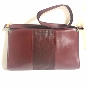 Vintage Christian Dior wine red leather clutch shoulder bag with engraved logo at center. Classic and beautiful purse. 060905r4