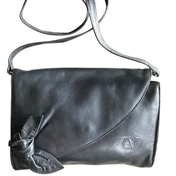 Vintage Valentino Garavani, Black nappa leather clutch purse, shoulder bag with tied bow, ribbon and V logo motif at front.