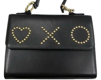 Vintage MOSCHINO black leather handbag in classic kelly purse style with golden studded heart, X, and O, playful motifs. 061105re1