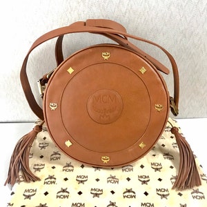 Vintage MCM suzy wong bag, brown grained leather round shoulder bag with studs and fringes. Designed by Michael Cromer. Nature. 060531r8