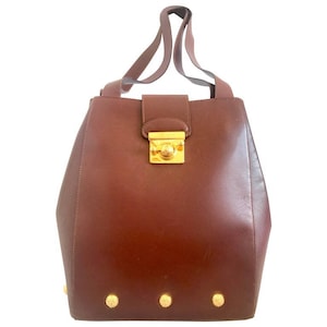 Vintage Salvatore Ferragamo brown leather purse with gold tone elegant closure. Featuring Ferragamo charms. 060516re4