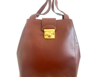 Vintage Salvatore Ferragamo brown leather purse with gold tone elegant closure. Featuring Ferragamo charms. 060516re4