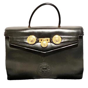 Vintage Gianni Versace black leather Kelly style bag with Medallion Sunburst charms. Gorgeous masterpiece. 070618k4r