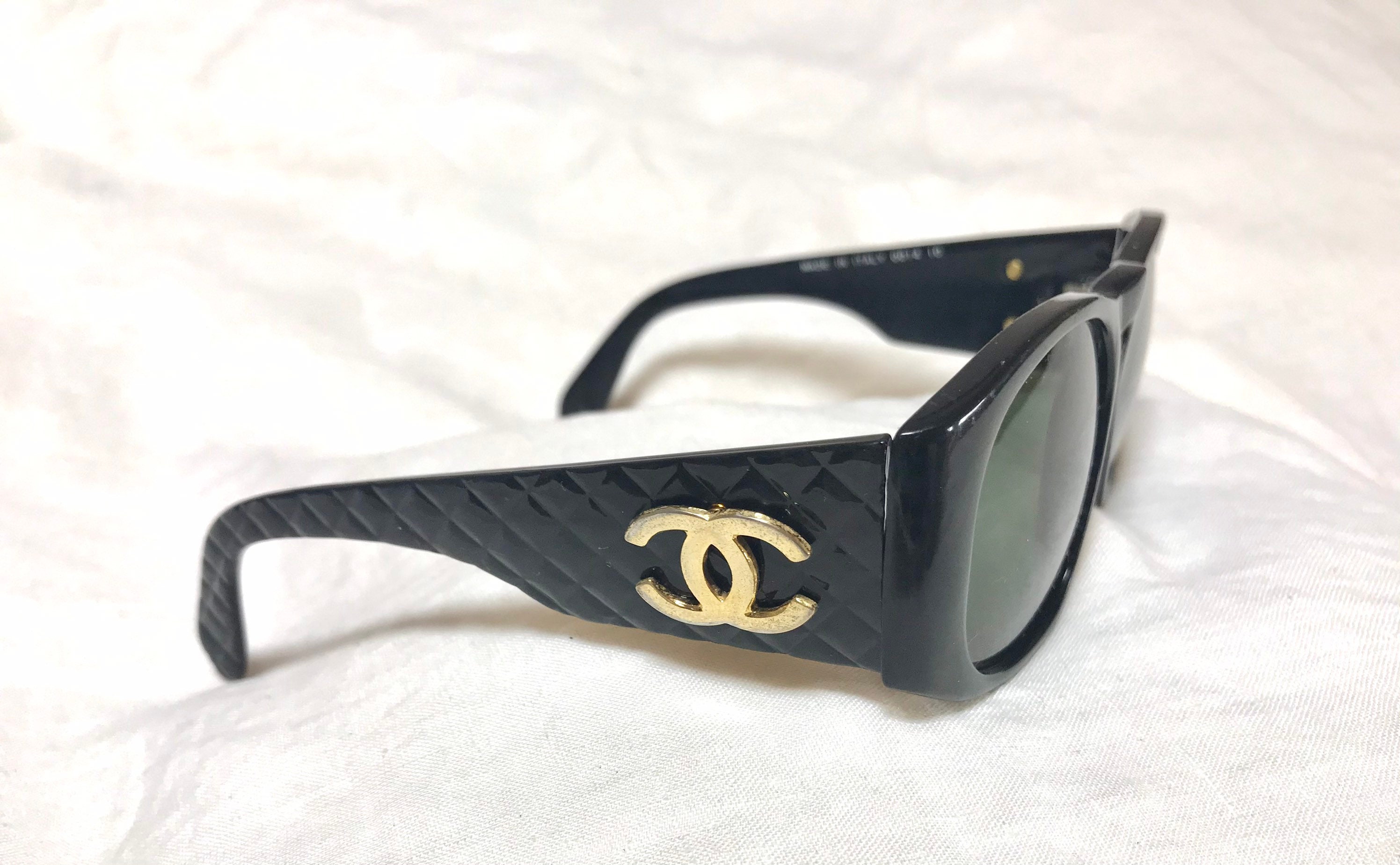 Vintage CHANEL black frame sunglasses with large CC charms at