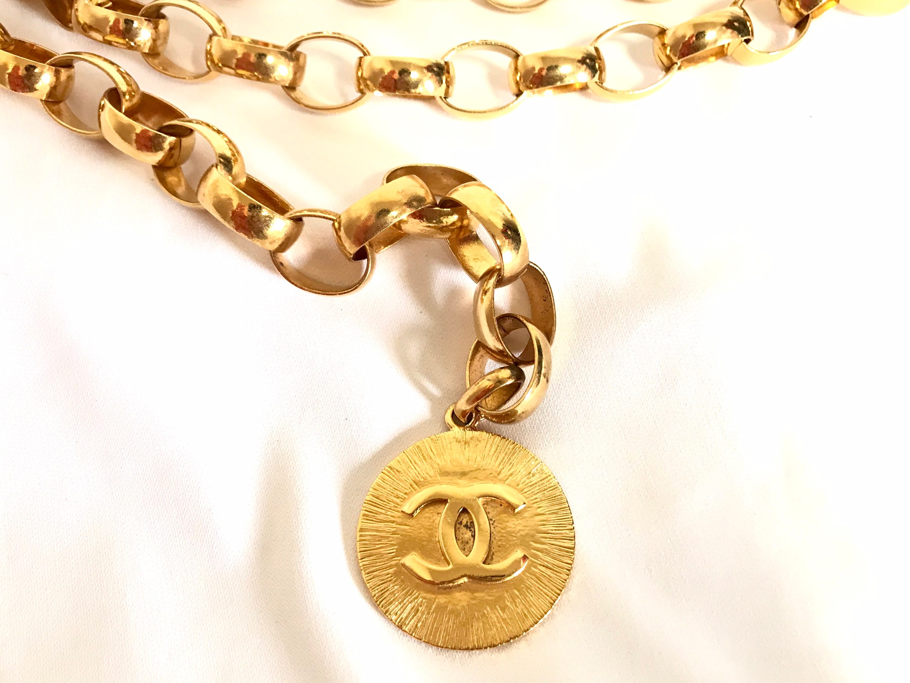 Vintage CHANEL golden thick chain belt with logo engraved bar motifs and a  round charm to the end. Must have gorgeous accessory.
