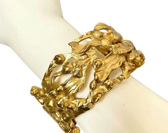 Vintage Yves Saint Laurent YSL sculptural arabesque motif gold tone bangle bracelet with embossed logo inside. Made in France. 080520ys1