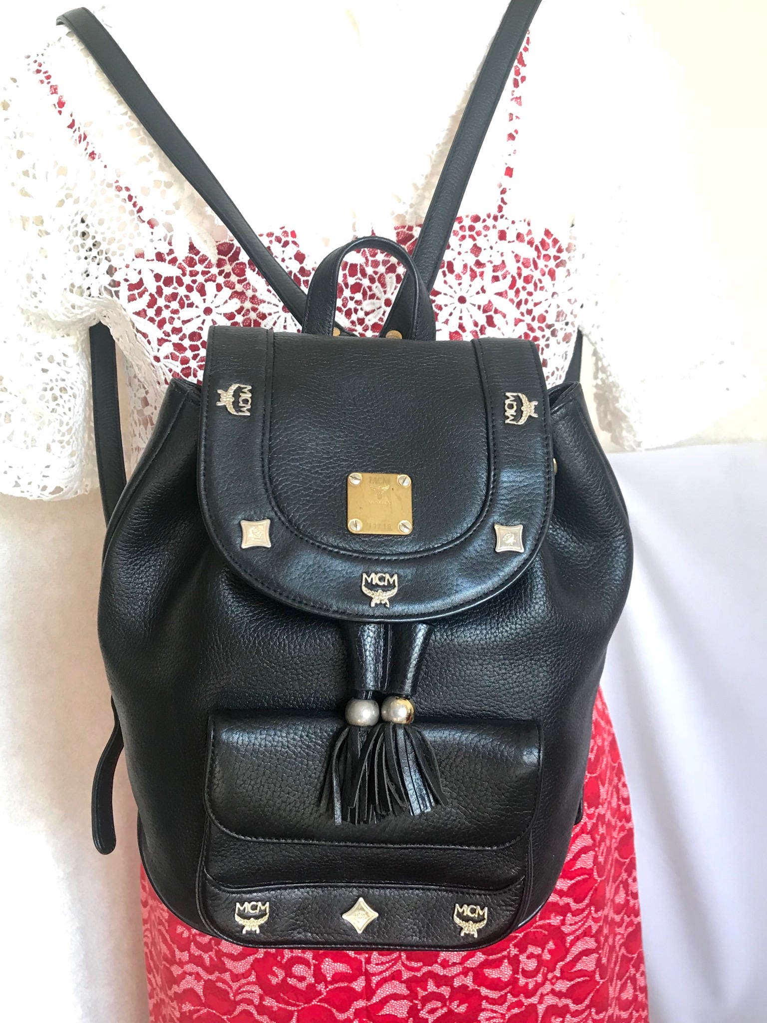 Vintage MCM Black Backpack With Golden Studded Logo Motifs Vintage MCM Black Backpack With Golden Studded Logo Motifs