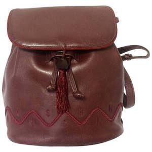 Vintage MOSCHINO genuine dark wine nappa leather backpack with tassel and logo embroidery motifs. Small to Medium size for daily use. 0704re