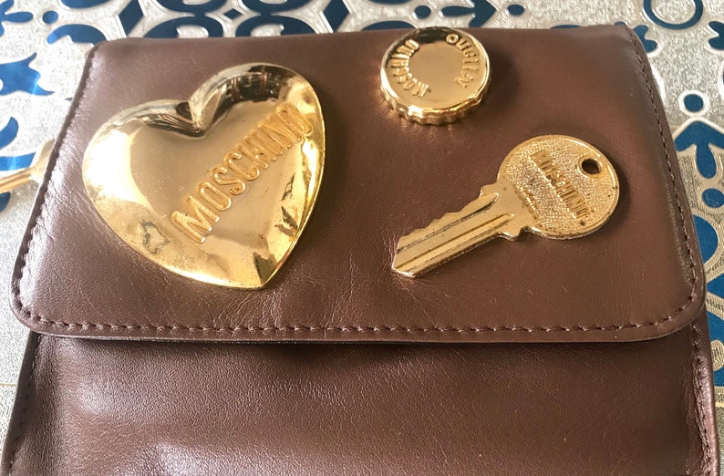 So chic and mod. Vintage MOSCHINO brown leather purse can be fanny bag clutch bag with large golden heart and key motifs
