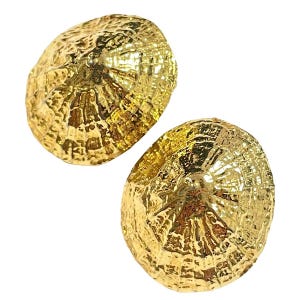 May include: A pair of gold-toned earrings shaped like conical seashells. Each earring features a textured, ridged surface that radiates from a central point, mimicking the natural organic structure of a limpet shell with a metallic finish.