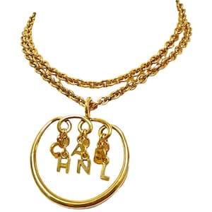 Vintage CHANEL golden long chain necklace with round logo letter dangling pendant top. Rare and adorable jewelry. 070204ac1
