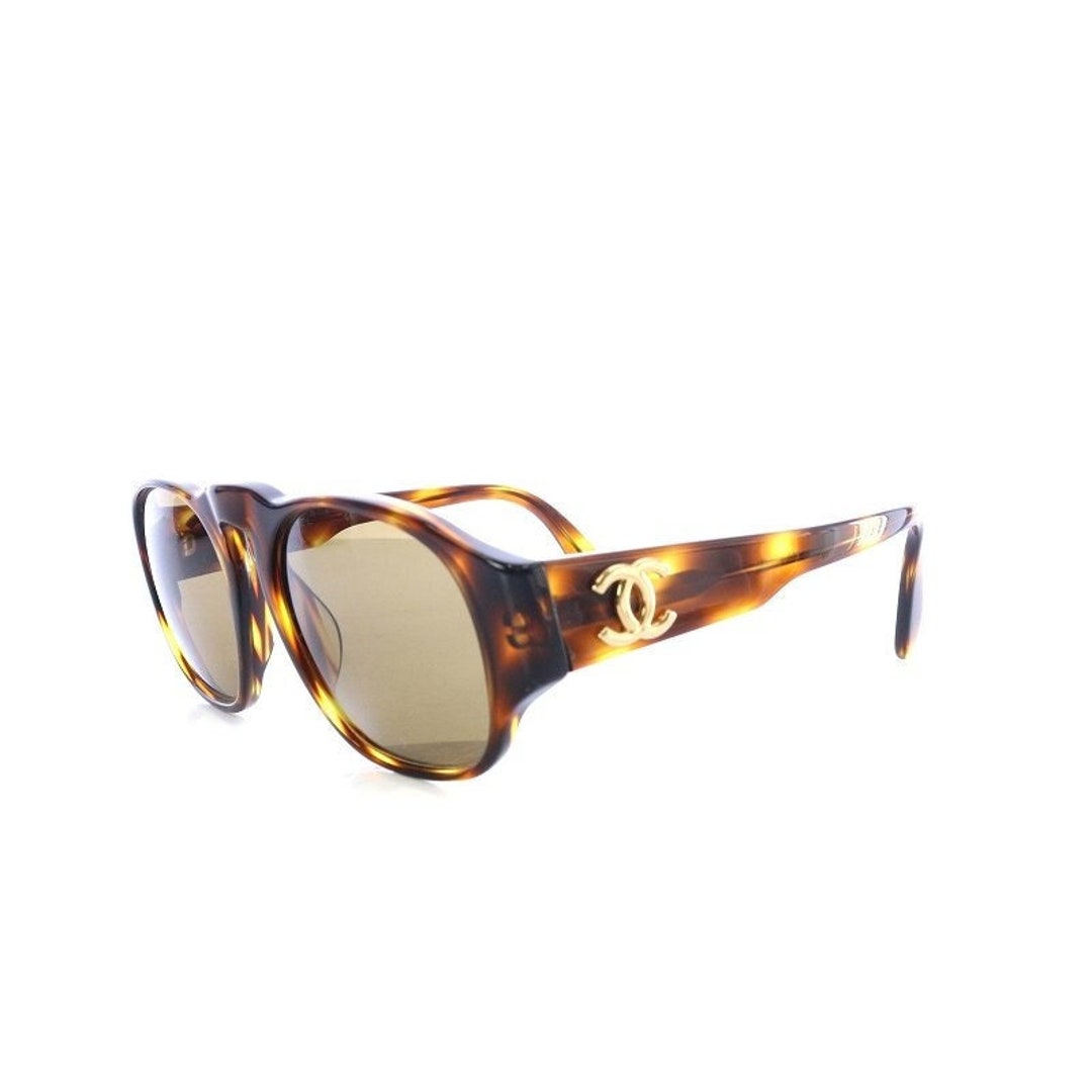 Vintage CHANEL black oval frame sunglasses with golden CC motifs