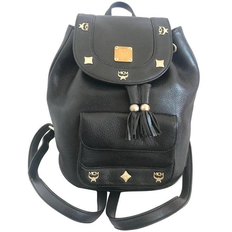 Vintage MCM Black Backpack With Golden Studded Logo Motifs Vintage MCM Black Backpack With Golden Studded Logo Motifs