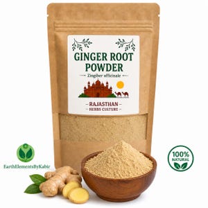 May include: A brown paper pouch of Ginger Root Powder with a label featuring a red building, camels, and the text GINGER ROOT POWDER, Zingiber officinale, RAJASTHAN, HERBS CULTURE. A wooden bowl contains the powder, with fresh ginger root nearby.