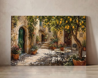 May include: A rectangular canvas print depicting a Mediterranean courtyard scene with a lemon tree in a terracotta pot, a small round metal table with two chairs, stone steps, and potted pink flowers against rustic beige stone walls.