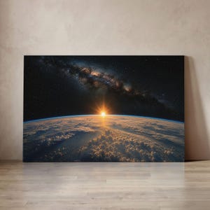 May include: A rectangular wall art canvas featuring a high-resolution space photograph of the Earth's horizon at sunrise. The image displays a bright sunburst, a dense layer of clouds over the planet, and the Milky Way galaxy in the dark sky.