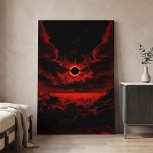 May include: A vertical rectangular wall art print depicting a total solar eclipse set against a dramatic sky filled with deep red clouds. The central black sun is surrounded by a vibrant red corona, with dark, textured clouds below and above.