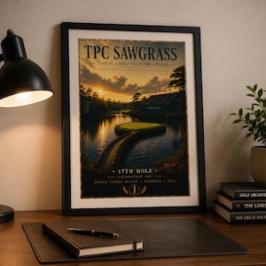 May include: A framed poster of the TPC Sawgrass The Players Stadium Course 17th hole, featuring a sunset over the island green and water. The text reads TPC Sawgrass, The Players Stadium Course, 17th Hole, Established 1980, Ponte Vedra Beach, Florida, USA.