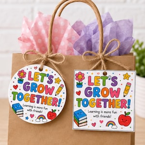 May include: A brown paper gift bag with two hanging tags, one circular and one square, both featuring the colorful text "LET'S GROW TOGETHER! Learning is more fun with friends!" alongside illustrations of a flower, pencil, books, apple, and rainbow.