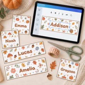 Puede incluir: Una tableta digital que muestra el nombre Addison, rodeada de varias etiquetas de papel rectangulares y cuadradas con ilustraciones otoñales de calabazas, setas, bellotas y hojas con los nombres Emma, Noah, Lucas, Amelia y Grayson.