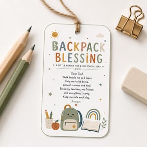 May include: A rectangular white tag with rounded corners and a jute string, featuring the text BACKPACK BLESSING A LITTLE PRAYER FOR A BIG SCHOOL YEAR and a prayer. The design includes a smiling sun, a backpack, an apple, and a rainbow.