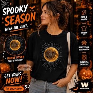 May include: A black short-sleeve t-shirt featuring a graphic of a full moon centred within a spider web. The text on the image includes "SPOOKY SEASON," "WEAR THE VIBES," "UNIQUE DESIGN THAT STANDS OUT," "GET YOURS NOW," and "SHOP NOW."