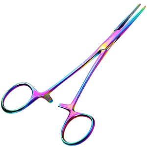 May include: A pair of rainbow-coloured stainless steel hemostatic forceps featuring a locking mechanism with finger rings at one end and long, serrated, pointed tips at the other. The metal surface displays a vibrant, iridescent gradient finish.