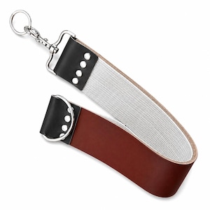 May include: A leather strap featuring a brown section and a white woven section, connected by black leather ends with silver-tone metal rivets. The strap includes a silver-tone swivel lobster clasp with a ring at one end and a D-ring at the other.