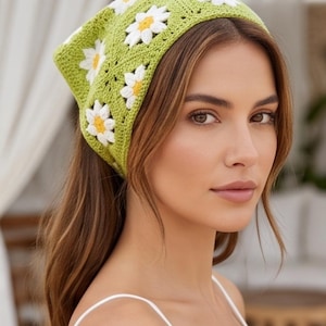 May include: A triangular crochet headscarf featuring a vibrant lime green base with a repeating pattern of white daisy motifs, each centered with a bright yellow circle. The accessory is constructed from interconnected square panels.