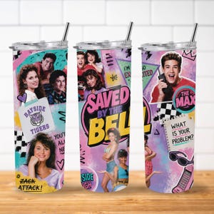 May include: A cylindrical tumbler with a metal straw featuring a colorful 90s-themed collage of the Saved by the Bell cast, Bayside Tigers logo, and text including "Saved by the Bell," "Zack Attack," "The Max," and "What is your problem?" on a purple background.