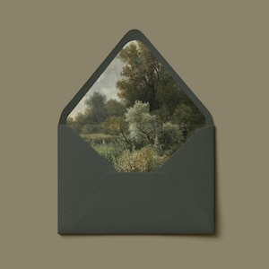 May include: A dark grey envelope with a pointed flap, featuring an interior liner printed with a detailed landscape painting of green trees, bushes, and tall grasses under a cloudy sky, creating a contrast between the solid exterior and art.